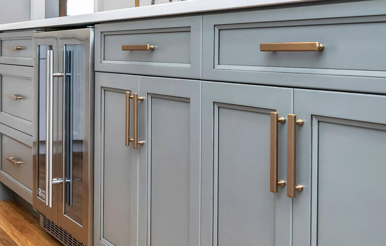 grey kitchen cabinets with bronze hardware