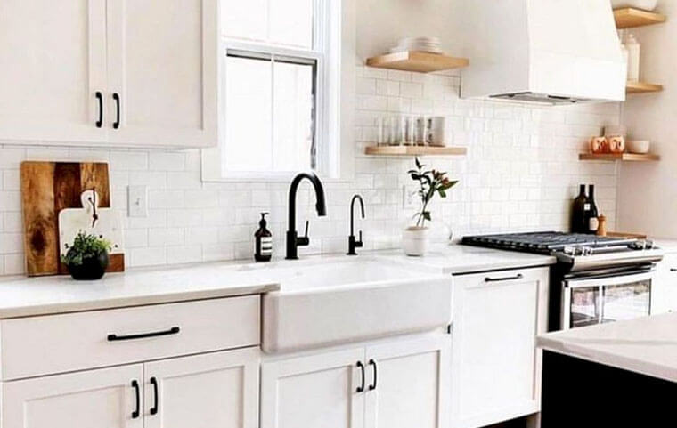 white cabinets with black hinges and handles