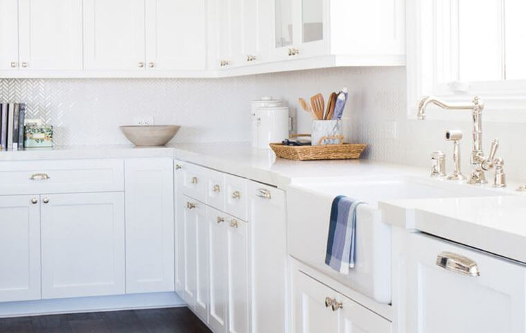 white kitchen cabinets with silver hardware